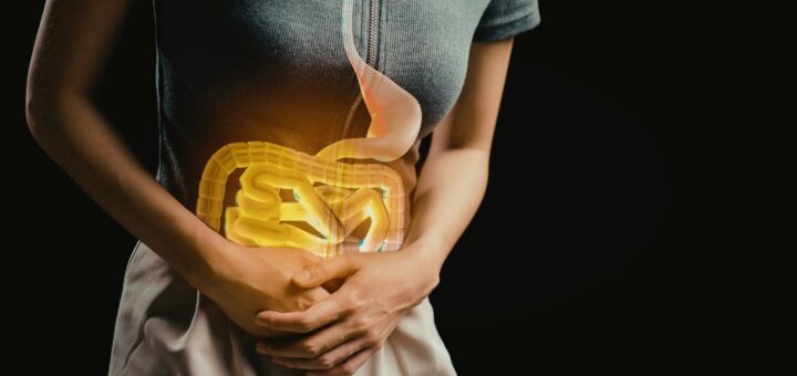 Osoba trzymająca się za brzuch, z graficzną wizualizacją jelit nałożoną na sylwetkę, symbolizującą dyskomfort trawienny i źle dobrany probiotyk.